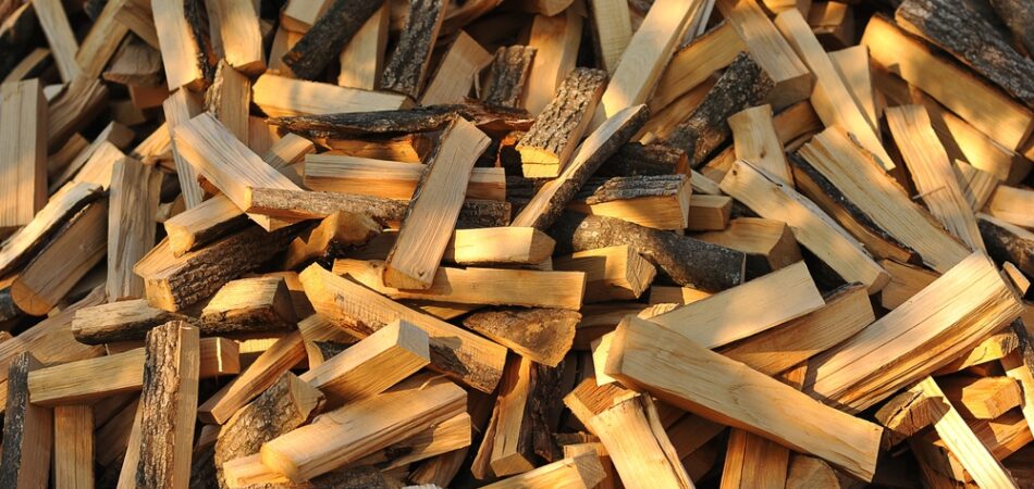 A,stack,of,firewood,with,a,hand,chopping,block.,chopped